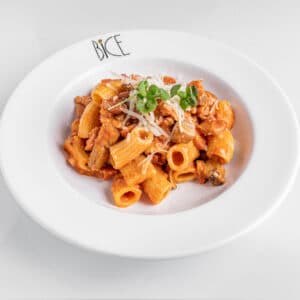 Pasta Pomodoro e Pancetta with velvety rosé sauce, mushrooms, crispy pancetta, and Parmesan