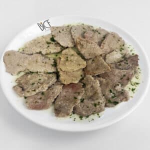 Char-grilled lamb chops with zesty chimichurri, served as a Bice cuisine dish