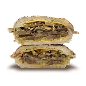 Italian sausage sandwich on a sesame panino bun with cheddar, honey mustard, caramelized onions, and eggplant