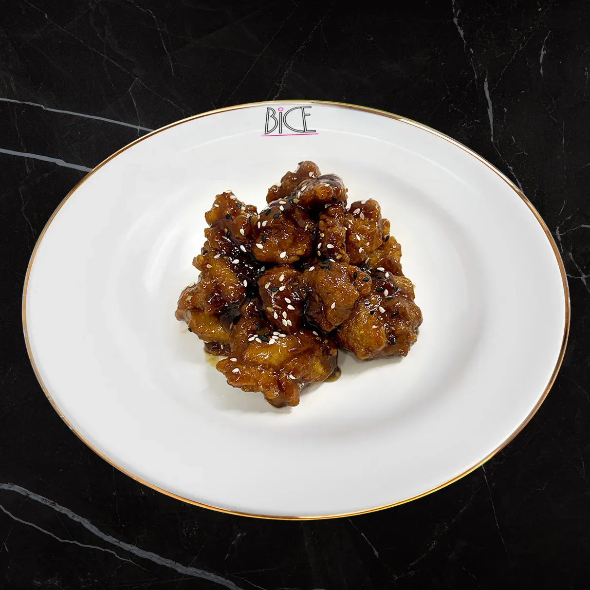 Crispy General Tao bites in sweet and spicy glaze topped with sesame seeds