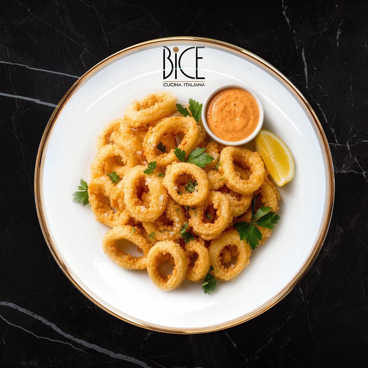 Golden Calamari Fritti rings with crispy batter and spicy mayo, an Italian cuisine appetizer