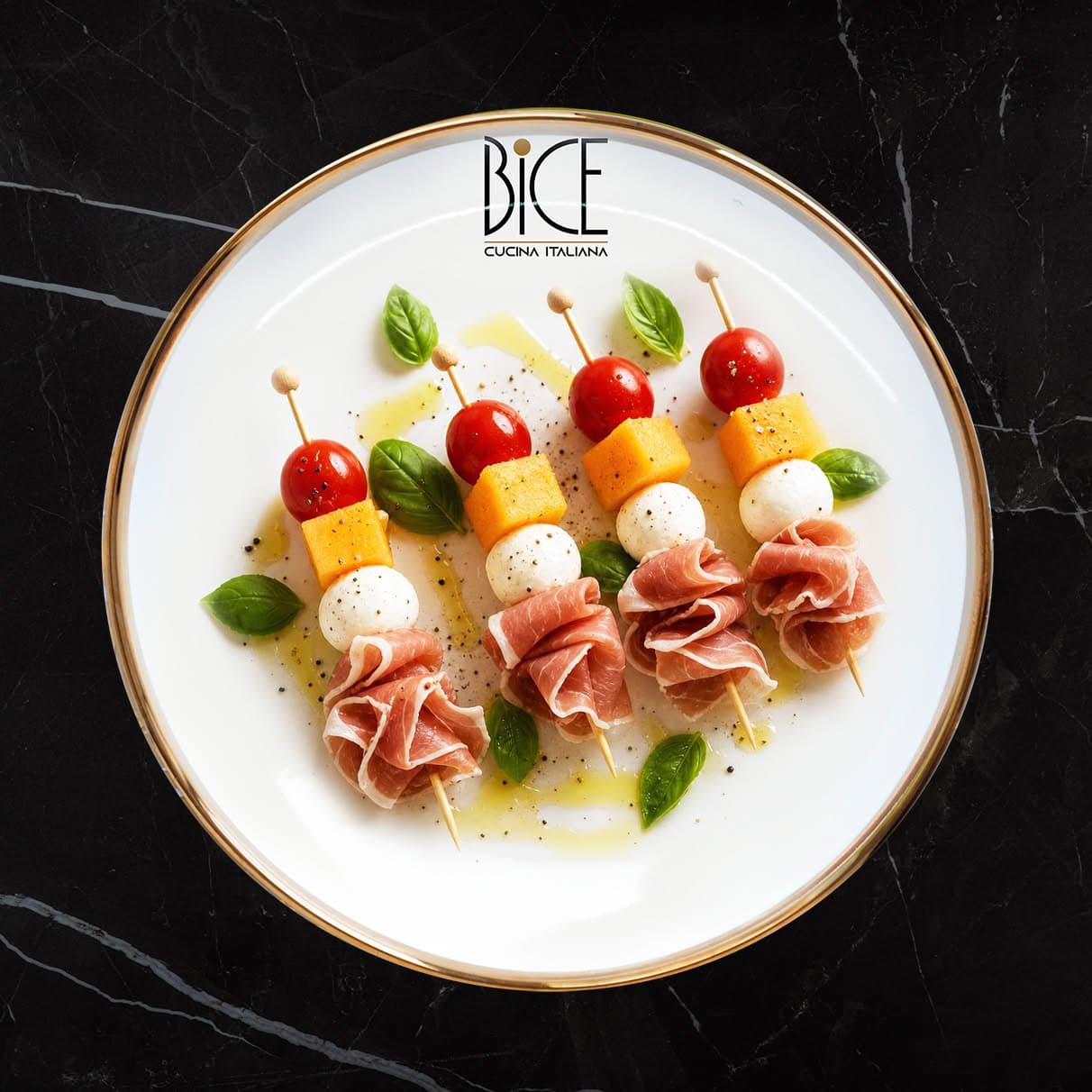 Italian cuisine skewers with prosciutto, bocconcini, fresh melon, and cherry tomatoes for elegant appetizers