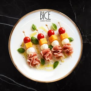 Prosciutto and bocconcini skewers Italian cuisine skewers with prosciutto, bocconcini, fresh melon, and cherry tomatoes for elegant appetizers