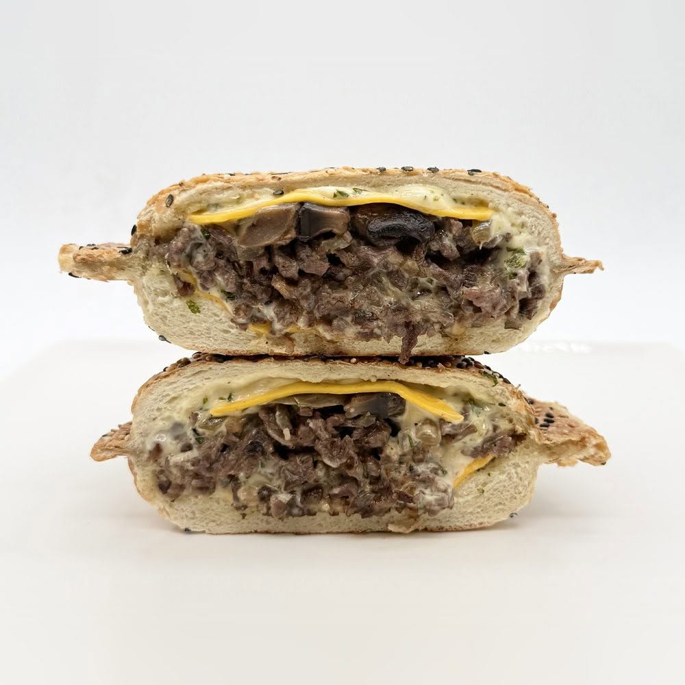 Panino au steak avec cheddar, sauce Bombe maison, oignons caramélisés et champignons