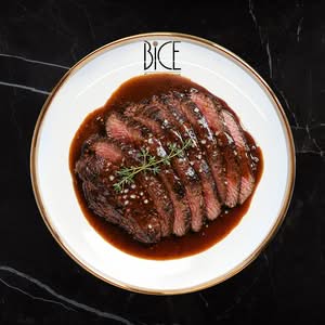 Bavette de bœuf juteuse nappée de sauce demi-glace, spécialité raffinée d’Italian cuisine